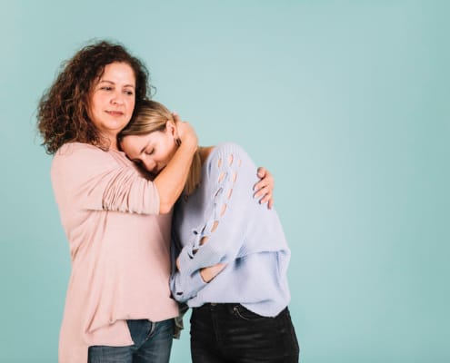 Mother comforting a teenager