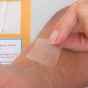 Personne mettant un patch anti-douleur CBD sur son bras